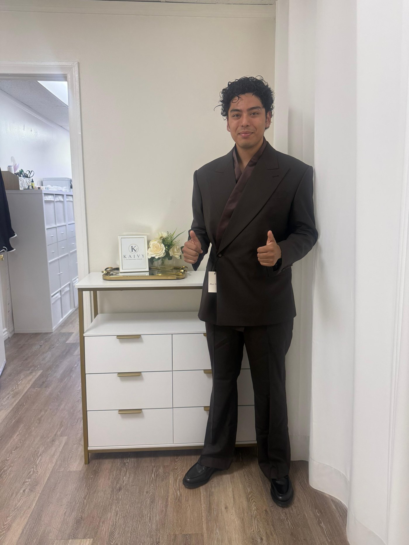 Man wearing a tailored brown suit altered at Kaivy Alteration Studio